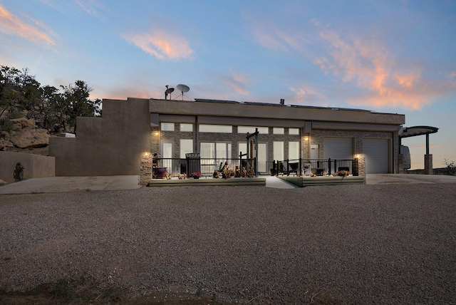 343 Webb Ranch Rd, Pie Town, NM 87827 - back of property featuring an attached garage and concrete driveway