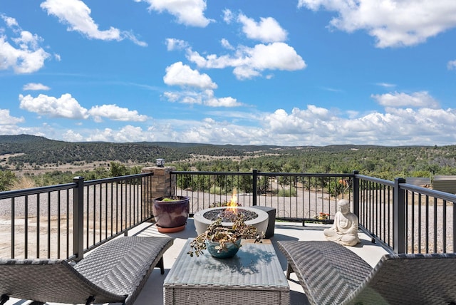 343 Webb Ranch Rd, Pie Town, NM 87827 - wooden deck featuring a fire pit and a wooded view
