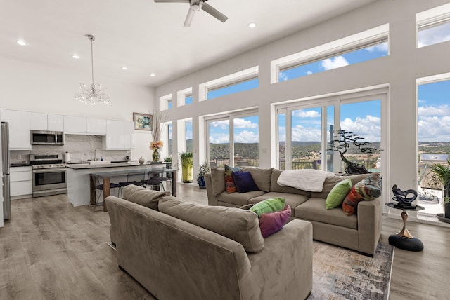 343 Webb Ranch Rd, Pie Town, NM 87827 - living area with a high ceiling, recessed lighting, a chandelier, healthy amount of natural light, and light wood finished floors