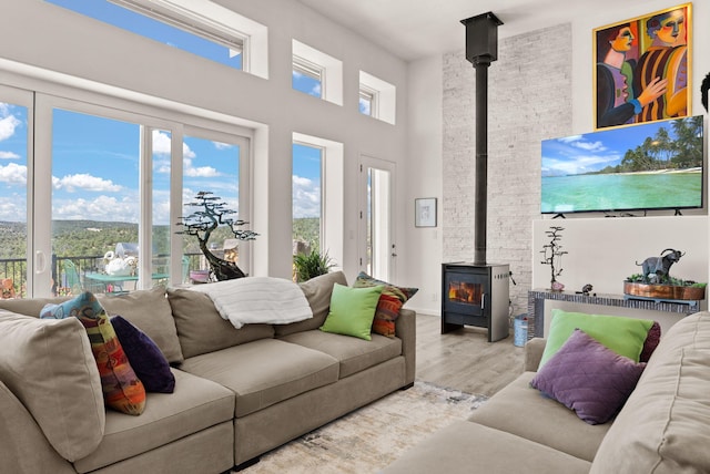 343 Webb Ranch Rd, Pie Town, NM 87827 - living area featuring a wood stove, wood finished floors, and a towering ceiling