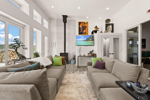 343 Webb Ranch Rd, Pie Town, NM 87827 - living room featuring a wood stove, recessed lighting, light wood-style floors, and a high ceiling