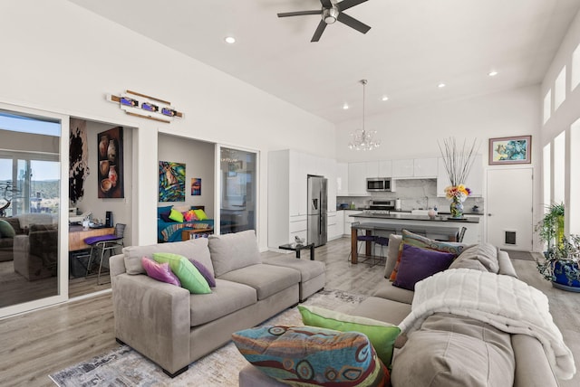 343 Webb Ranch Rd, Pie Town, NM 87827 - living room featuring a towering ceiling, a chandelier, ceiling fan, light wood-style flooring, and recessed lighting