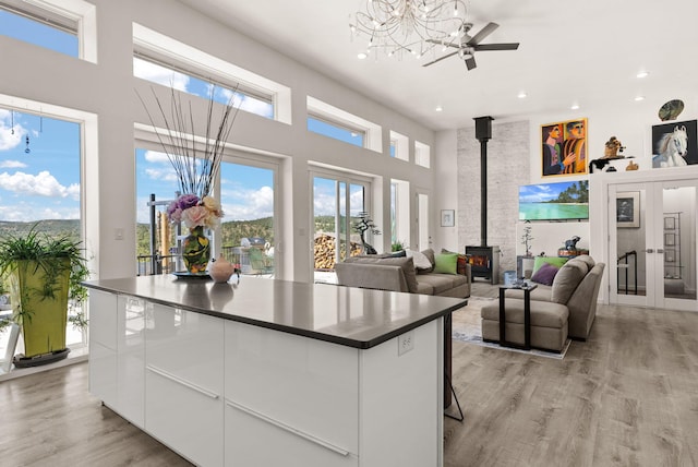 343 Webb Ranch Rd, Pie Town, NM 87827 - kitchen featuring dark countertops, modern cabinets, a center island, white cabinetry, and a towering ceiling