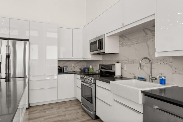 343 Webb Ranch Rd, Pie Town, NM 87827 - kitchen with appliances with stainless steel finishes, white cabinets, decorative backsplash, and modern cabinets