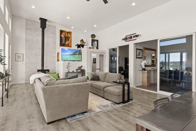 343 Webb Ranch Rd, Pie Town, NM 87827 - living room with a high ceiling, a wood stove, light wood-style floors, a ceiling fan, and recessed lighting