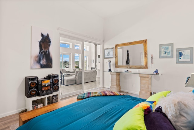343 Webb Ranch Rd, Pie Town, NM 87827 - bedroom featuring access to outside, wood finished floors, and a high ceiling