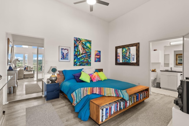 343 Webb Ranch Rd, Pie Town, NM 87827 - bedroom featuring access to exterior, light wood finished floors, a high ceiling, connected bathroom, and ceiling fan