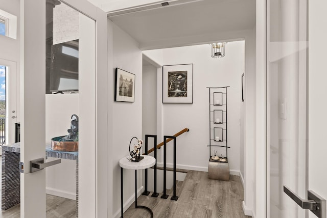 343 Webb Ranch Rd, Pie Town, NM 87827 - corridor featuring wood finished floors, a chandelier, and an upstairs landing