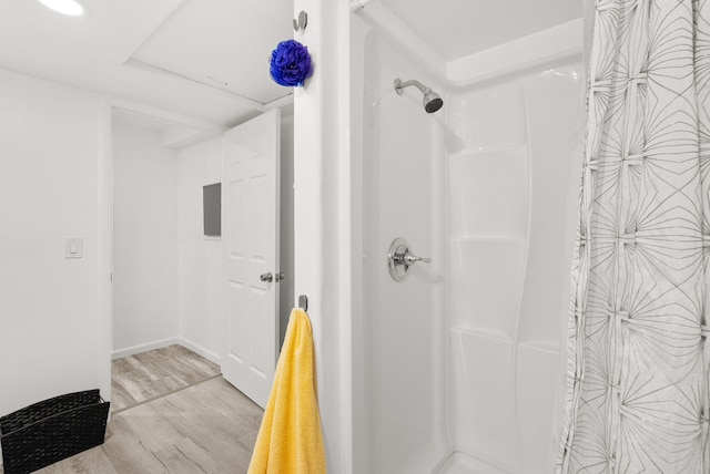 343 Webb Ranch Rd, Pie Town, NM 87827 - bathroom with a shower with shower curtain and wood finished floors