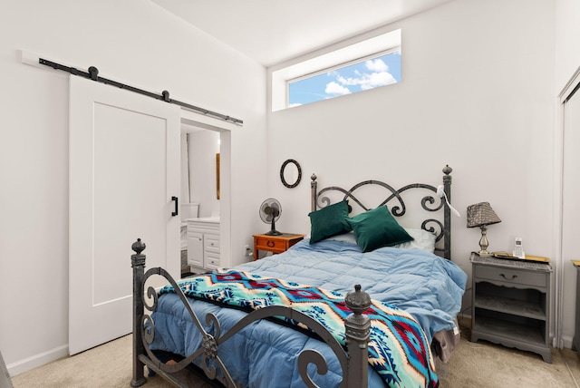 343 Webb Ranch Rd, Pie Town, NM 87827 - bedroom with a barn door, light colored carpet, and ensuite bathroom