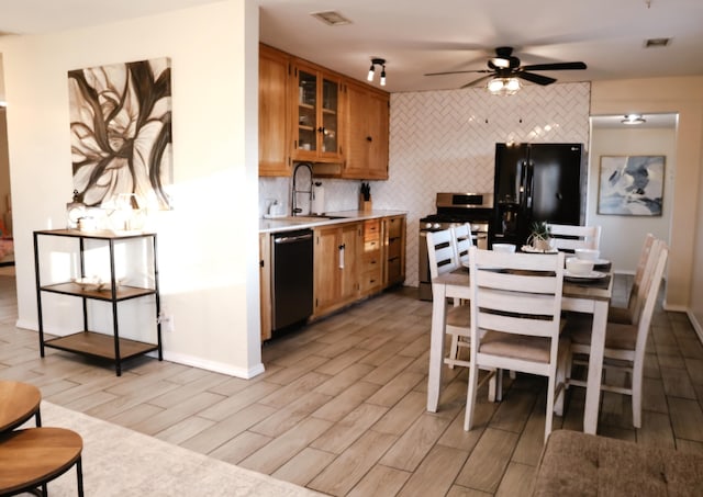 9002 Phoenix Ave NE, Albuquerque, NM 87112 - kitchen featuring dishwashing machine, freestanding refrigerator, light wood-type flooring, stainless steel stove, and brown cabinets