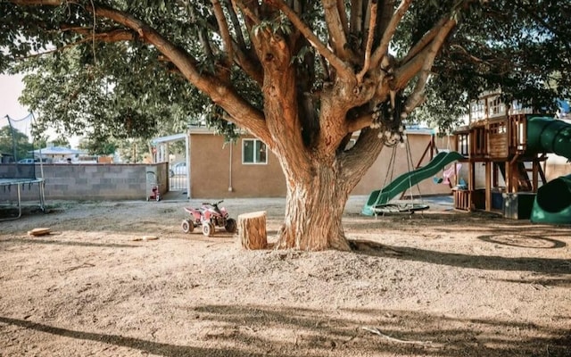 9002 Phoenix Ave NE, Albuquerque, NM 87112 - view of yard featuring a trampoline