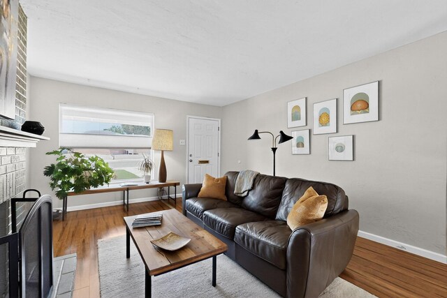 8206 Morrow Ave NE, Albuquerque, NM 87110 - living room with wood finished floors and a fireplace