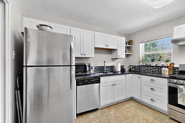 8206 Morrow Ave NE, Albuquerque, NM 87110 - kitchen featuring stainless steel appliances, open shelves, white cabinets, a textured ceiling, and dark stone counters