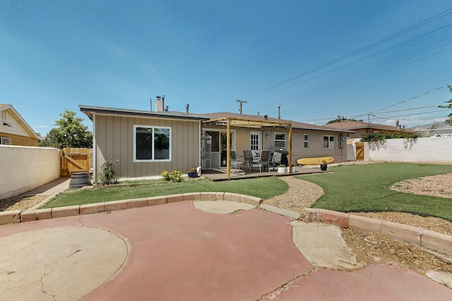 8206 Morrow Ave NE, Albuquerque, NM 87110 - back of property with board and batten siding, a fenced backyard, a patio area, and a gate