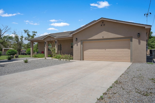 9 Elias Rd, Los Lunas, NM 87031 - ranch-style home featuring stucco siding, concrete driveway, and an attached garage
