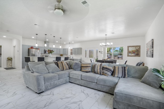 9 Elias Rd, Los Lunas, NM 87031 - living room with light marble finish flooring, a chandelier, recessed lighting, and a ceiling fan
