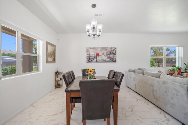 9 Elias Rd, Los Lunas, NM 87031 - dining space featuring light marble finish flooring and a chandelier