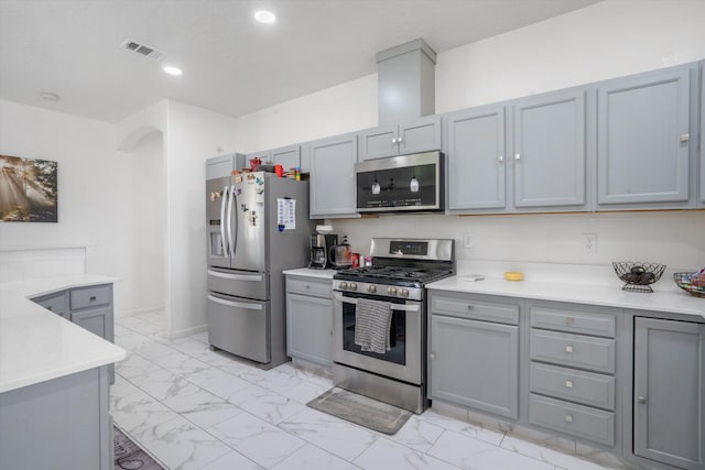 9 Elias Rd, Los Lunas, NM 87031 - kitchen featuring appliances with stainless steel finishes, gray cabinetry, light marble finish flooring, light countertops, and recessed lighting