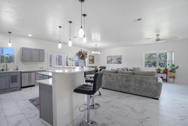 9 Elias Rd, Los Lunas, NM 87031 - kitchen featuring dishwasher, light marble finish floors, gray cabinets, a center island, and recessed lighting