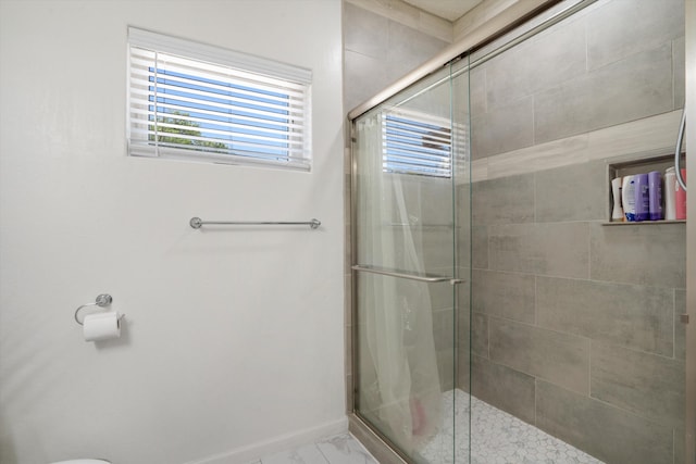 9 Elias Rd, Los Lunas, NM 87031 - bathroom featuring a shower stall and marble look tiles