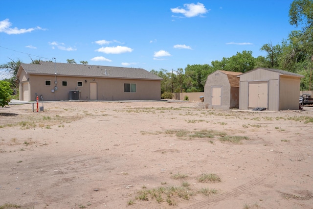 9 Elias Rd, Los Lunas, NM 87031 - rear view of house with a shed and a garage