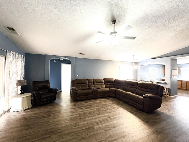 1543 White Pine Dr, Rio Rancho, NM 87144 - living area with arched walkways, wood finished floors, a ceiling fan, lofted ceiling, and a textured ceiling