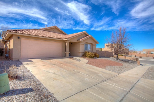 1543 White Pine Dr, Rio Rancho, NM 87144 - mediterranean / spanish home with stucco siding, a tile roof, concrete driveway, and an attached garage