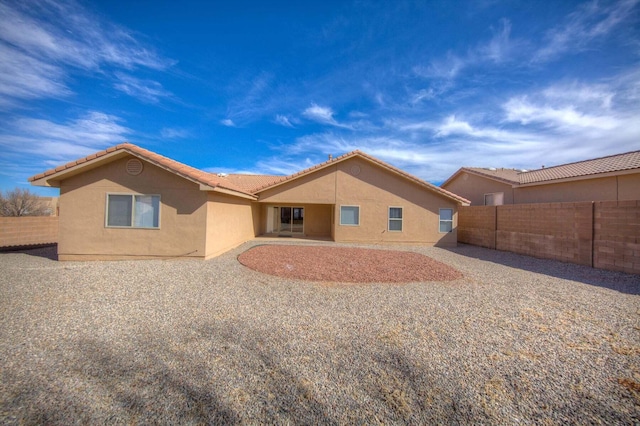 1543 White Pine Dr, Rio Rancho, NM 87144 - rear view of house featuring stucco siding, a fenced backyard, and a tile roof