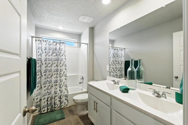 3209 Tazanita Loop SE, Rio Rancho, NM 87124 - bathroom with shower / bathtub combination with curtain, double vanity, wood finished floors, a textured ceiling, and recessed lighting