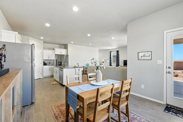 3209 Tazanita Loop SE, Rio Rancho, NM 87124 - dining space with light wood-style floors, recessed lighting, and a textured ceiling