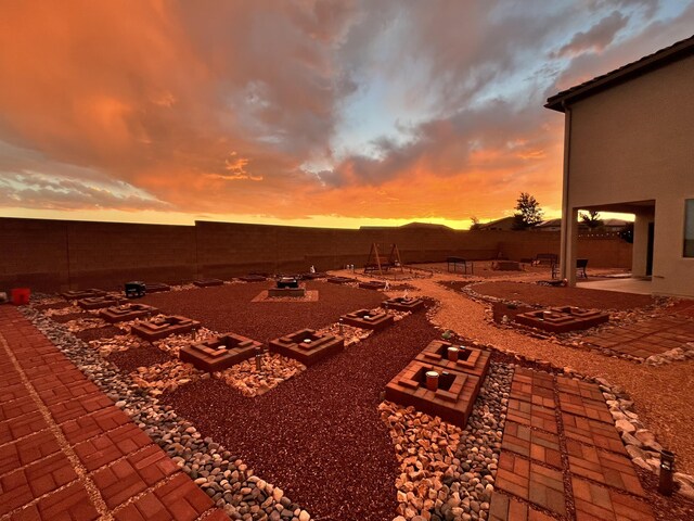 3209 Tazanita Loop SE, Rio Rancho, NM 87124 - yard at dusk with a patio and a fenced backyard