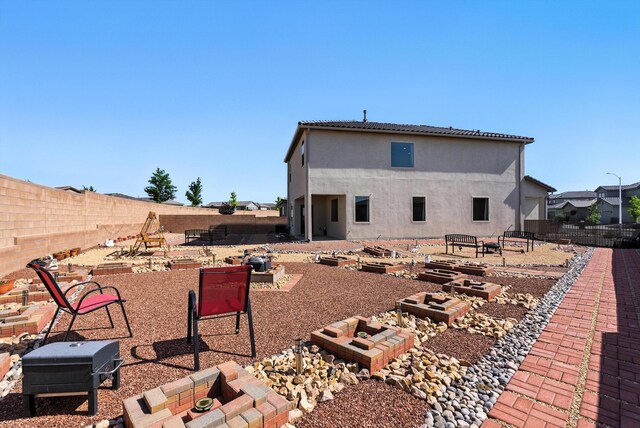 3209 Tazanita Loop SE, Rio Rancho, NM 87124 - rear view of property with a fenced backyard, a patio, a vegetable garden, and stucco siding