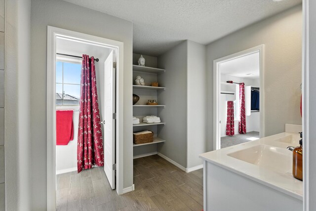 3209 Tazanita Loop SE, Rio Rancho, NM 87124 - hall featuring light wood-style flooring and a textured ceiling