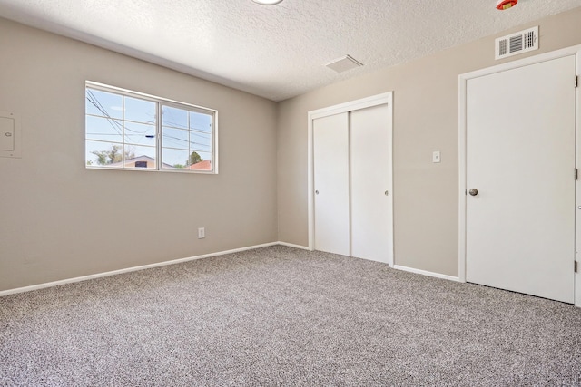 5711 Bohemio Ct SW, Albuquerque, NM 87105 - unfurnished bedroom with carpet floors, a closet, and a textured ceiling