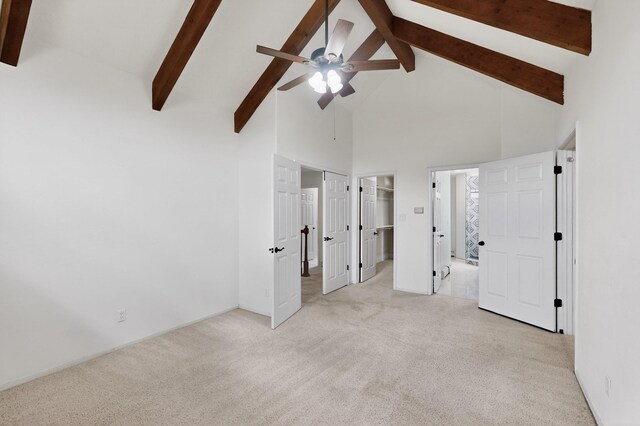 8 Fawn Rd, Cedar Crest, NM 87008 - unfurnished bedroom with high vaulted ceiling, beamed ceiling, light colored carpet, a walk in closet, and a ceiling fan