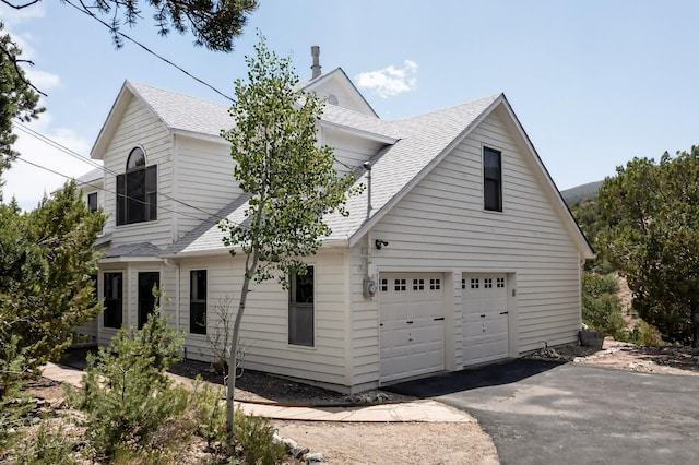 8 Fawn Rd, Cedar Crest, NM 87008 - view of home's exterior featuring a shingled roof, driveway, and a garage