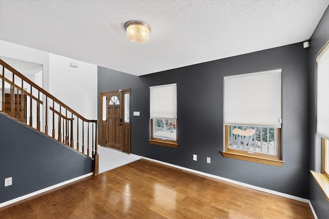 8 Fawn Rd, Cedar Crest, NM 87008 - foyer entrance featuring wood finished floors, stairway, plenty of natural light, and a textured ceiling