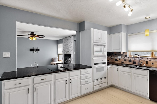 8 Fawn Rd, Cedar Crest, NM 87008 - kitchen with white appliances, ceiling fan, white cabinets, backsplash, and a textured ceiling