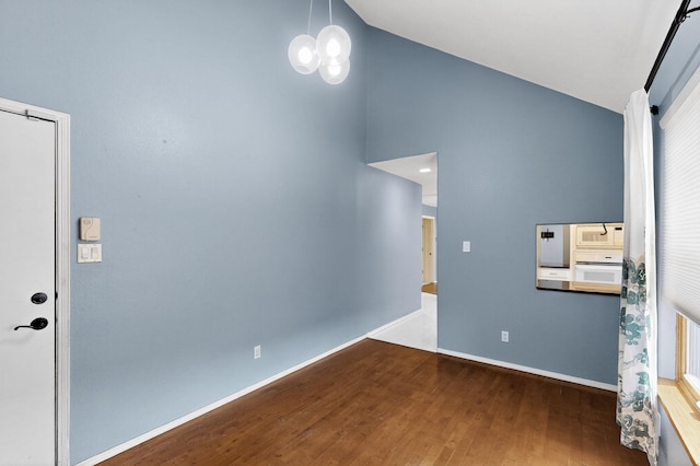 8 Fawn Rd, Cedar Crest, NM 87008 - unfurnished room featuring wood finished floors, high vaulted ceiling, and a chandelier