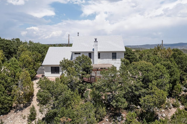 8 Fawn Rd, Cedar Crest, NM 87008 - back of house with a chimney, a deck, and a shingled roof