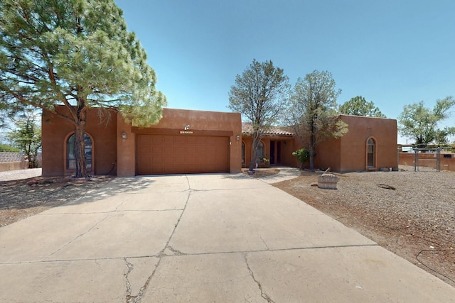 4904 Alberta Ln NW, Albuquerque, NM 87120 - southwest-style home featuring stucco siding, a garage, and driveway