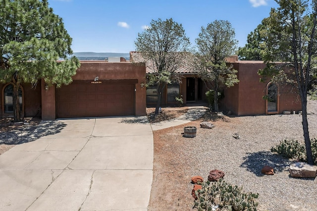 4904 Alberta Ln NW, Albuquerque, NM 87120 - adobe home with stucco siding, driveway, and an attached garage