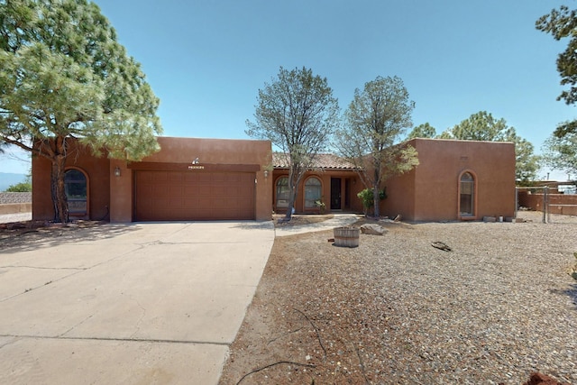 4904 Alberta Ln NW, Albuquerque, NM 87120 - adobe home with stucco siding, a garage, driveway, and a tiled roof