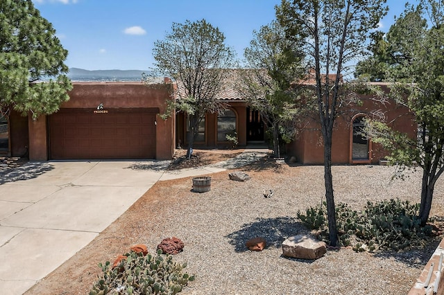 4904 Alberta Ln NW, Albuquerque, NM 87120 - pueblo revival-style home featuring a garage, driveway, and stucco siding