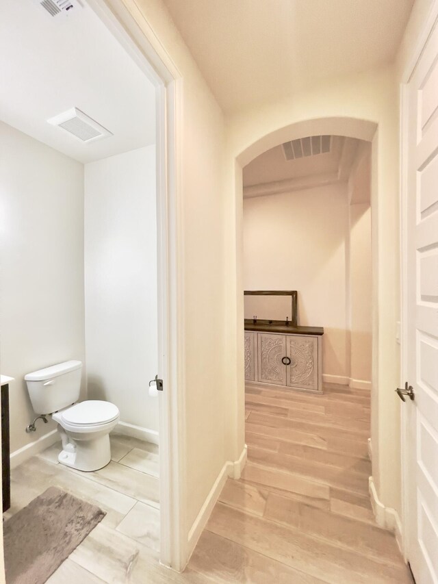 3237 Fennel Rd NE, Rio Rancho, NM 87144 - hall with arched walkways and wood finished floors