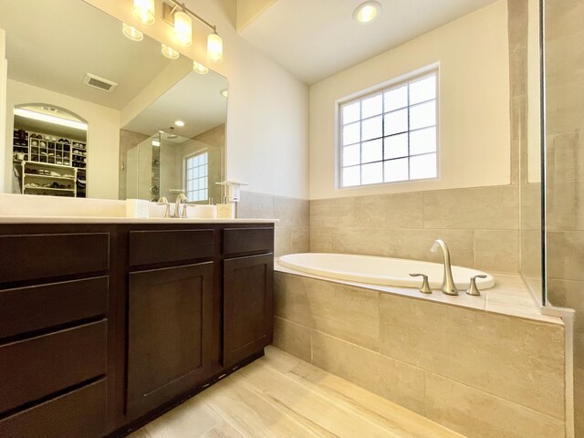 3237 Fennel Rd NE, Rio Rancho, NM 87144 - full bath with healthy amount of natural light, vanity, a garden tub, and a walk in closet
