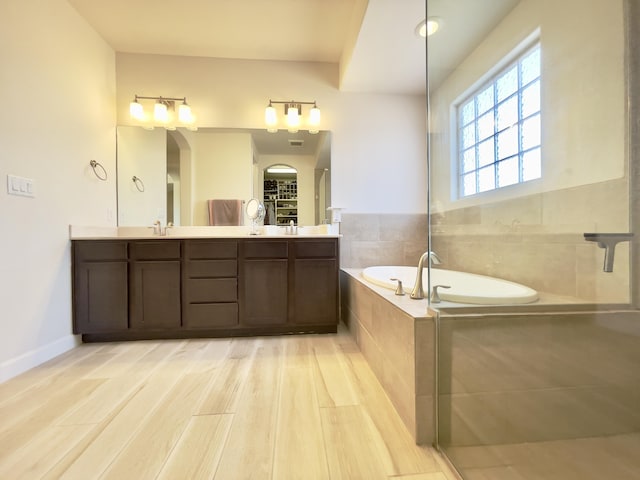 3237 Fennel Rd NE, Rio Rancho, NM 87144 - full bathroom with double vanity, a bath, and wood finished floors