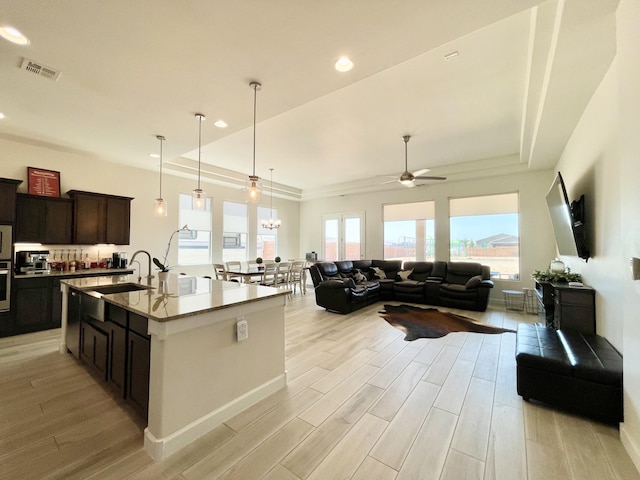 3237 Fennel Rd NE, Rio Rancho, NM 87144 - kitchen with light wood-type flooring, ceiling fan, open floor plan, a raised ceiling, and recessed lighting
