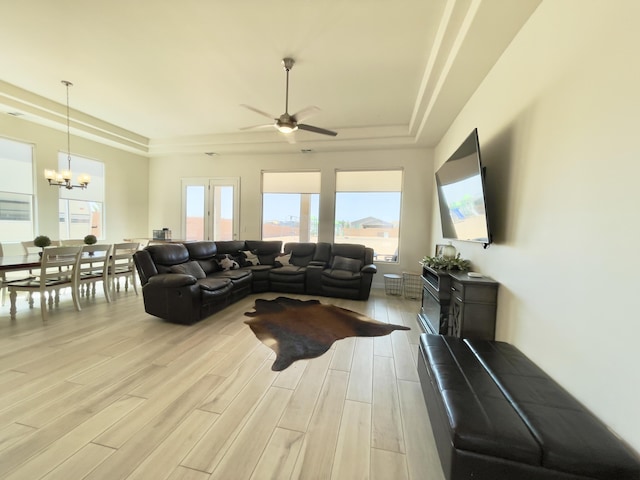 3237 Fennel Rd NE, Rio Rancho, NM 87144 - living area featuring a raised ceiling, a chandelier, light wood-style floors, and ceiling fan